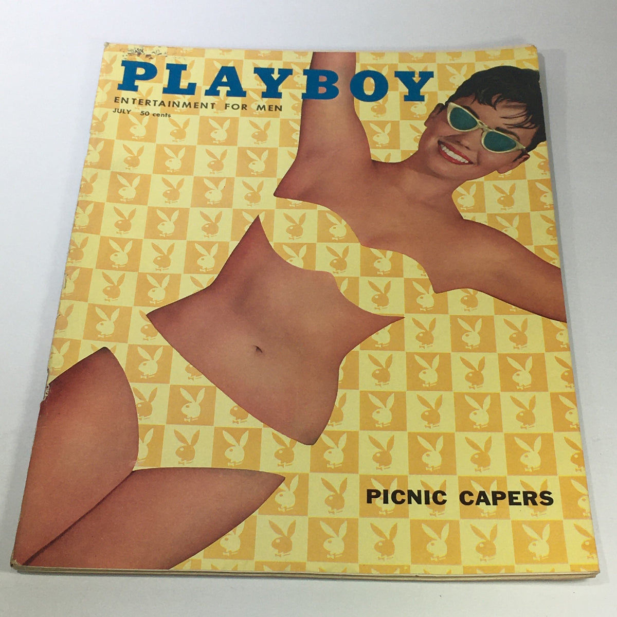 VTG Playboy Magazine July 1958 cover featuring a bikini girl in vibrant summer colors with the title Picnic Capers, showcasing iconic artwork and vintage appeal.
