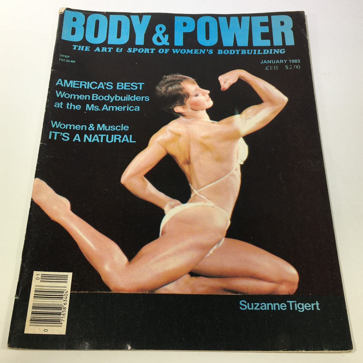 Vintage Body & Power Magazine January 1983 featuring a stunning cover by Suzanne Tigert, showcasing a female bodybuilder in a dynamic pose.