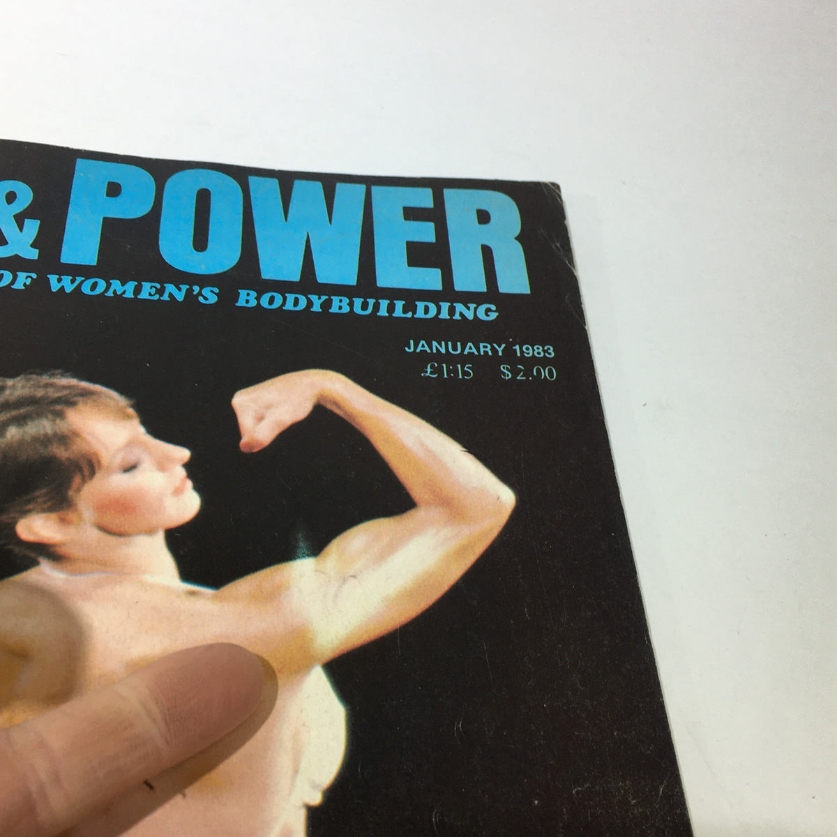 Close-up of the Vintage Body & Power Magazine from January 1983, highlighting Suzanne Tigert's cover with emphasis on the muscular female figure.