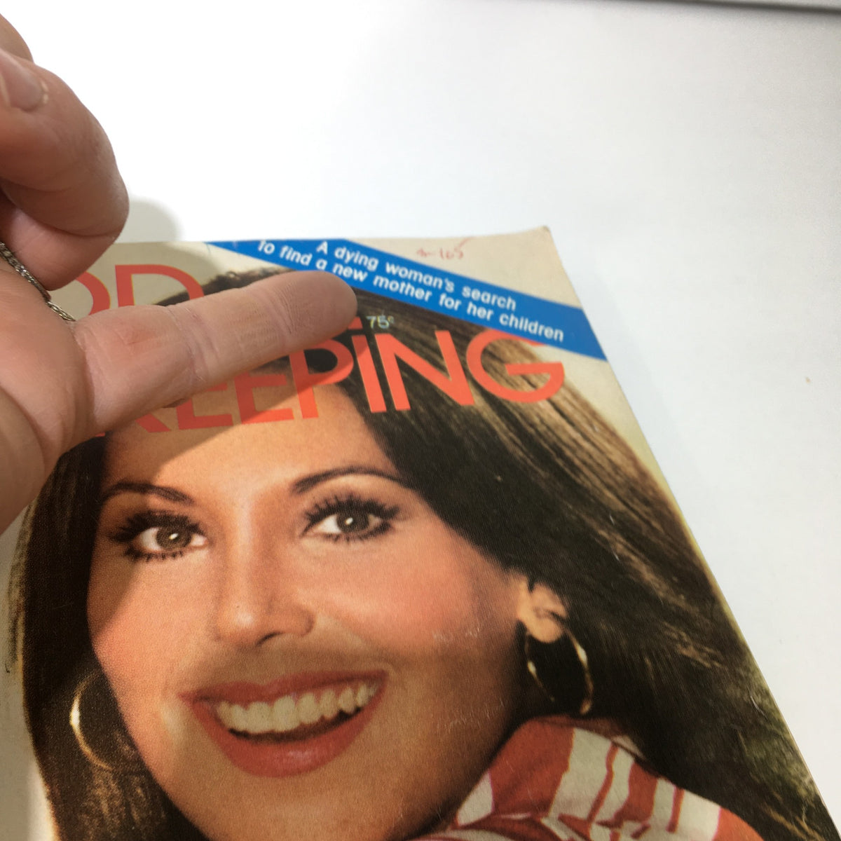 Another view of the July 1975 Good Housekeeping magazine cover, highlighting Marlo Thomas's smiling face and an article headline about a dying woman's search for a new mother for her children. Reflects the emotional and cultural themes of the time.