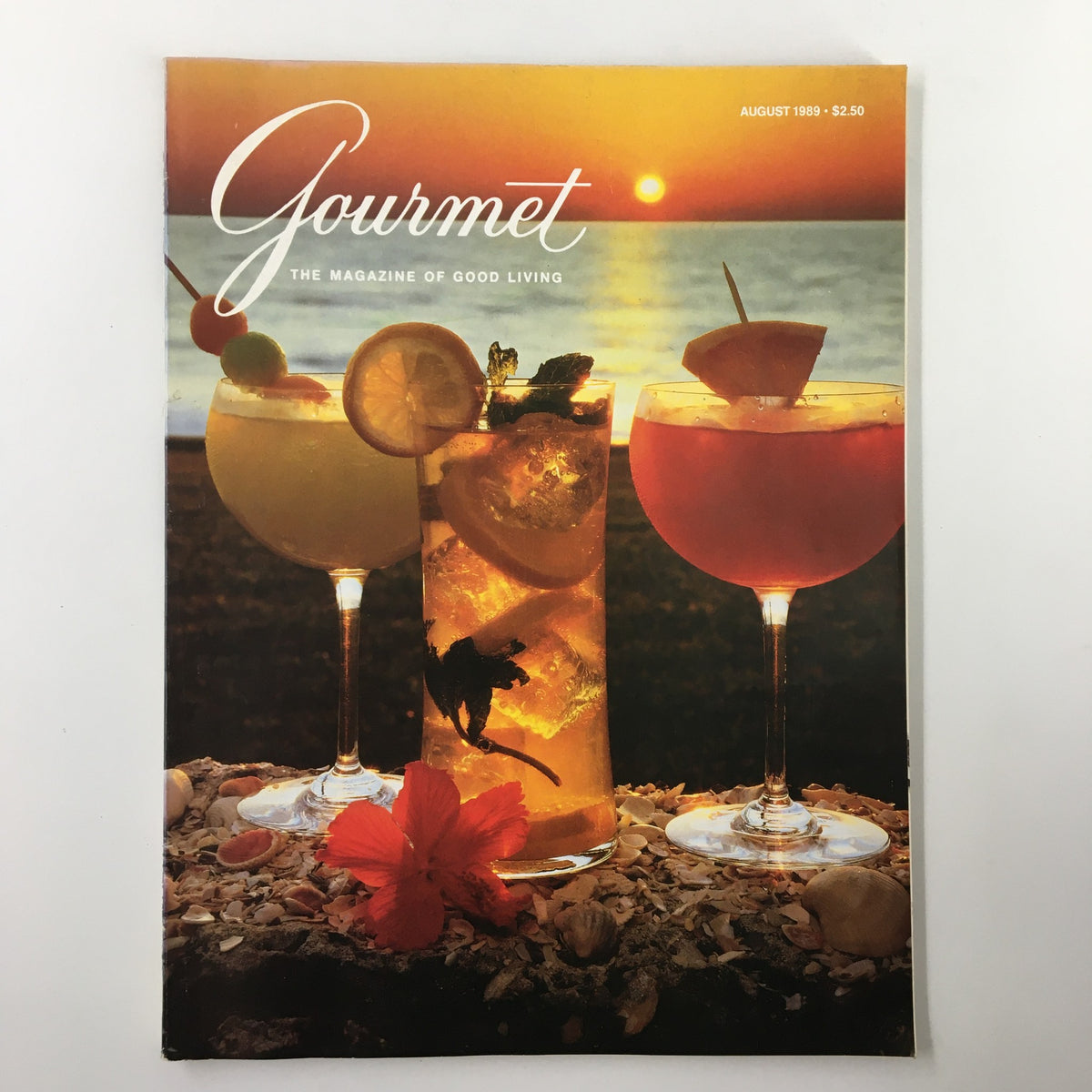 Cover of VTG Gourmet Magazine August 1989 featuring vibrant tropical drinks against a sunset backdrop. A collectible piece showcasing quintessential summer cocktails.