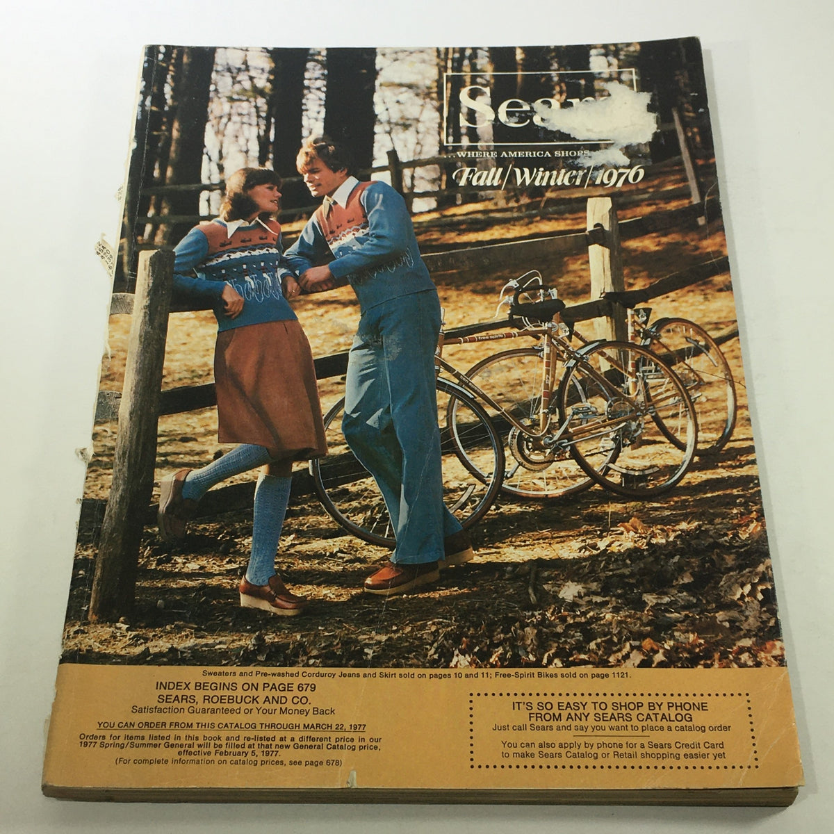 Vintage Sears Catalog from Fall/Winter 1976 showcasing a couple in retro fashion against a wooded backdrop, featuring iconic styles from the era. Perfect for collectors and those interested in 1970s nostalgia.