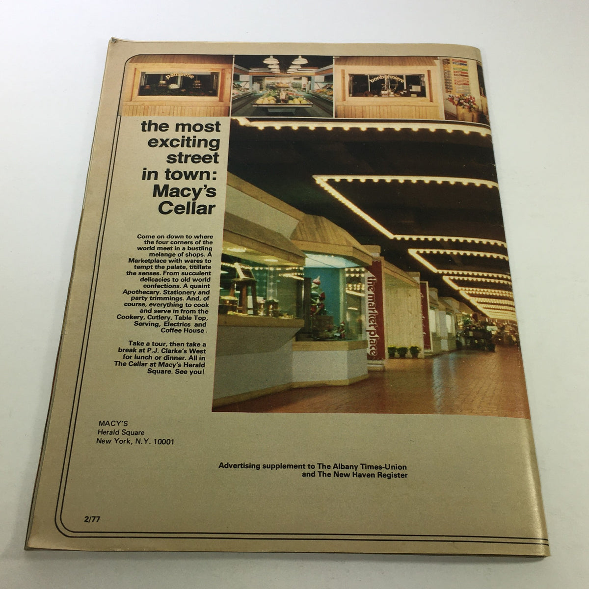 Cover of VTG Macy's The Cellar Catalog: February 1977 - Furniture Price Guide, showcasing a vibrant shopping environment with illuminated signage and displays.