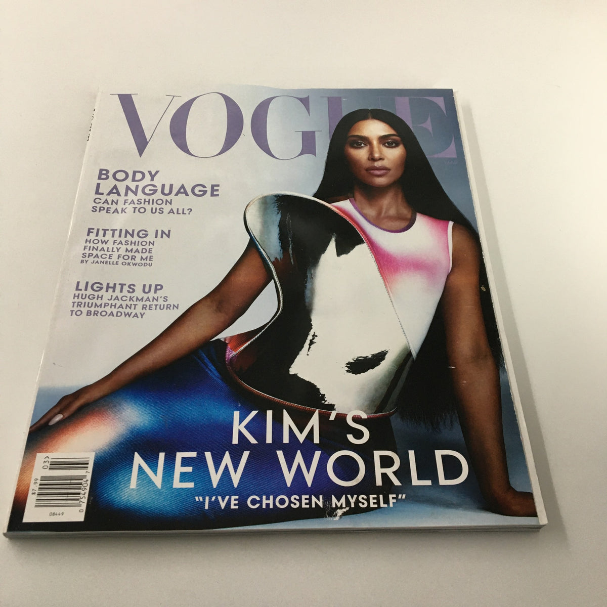 Vogue Magazine March 2022 cover featuring Kim Kardashian titled 'Kim's New World'. The cover showcases Kardashian in a striking pose, highlighting contemporary fashion trends and body language themes.