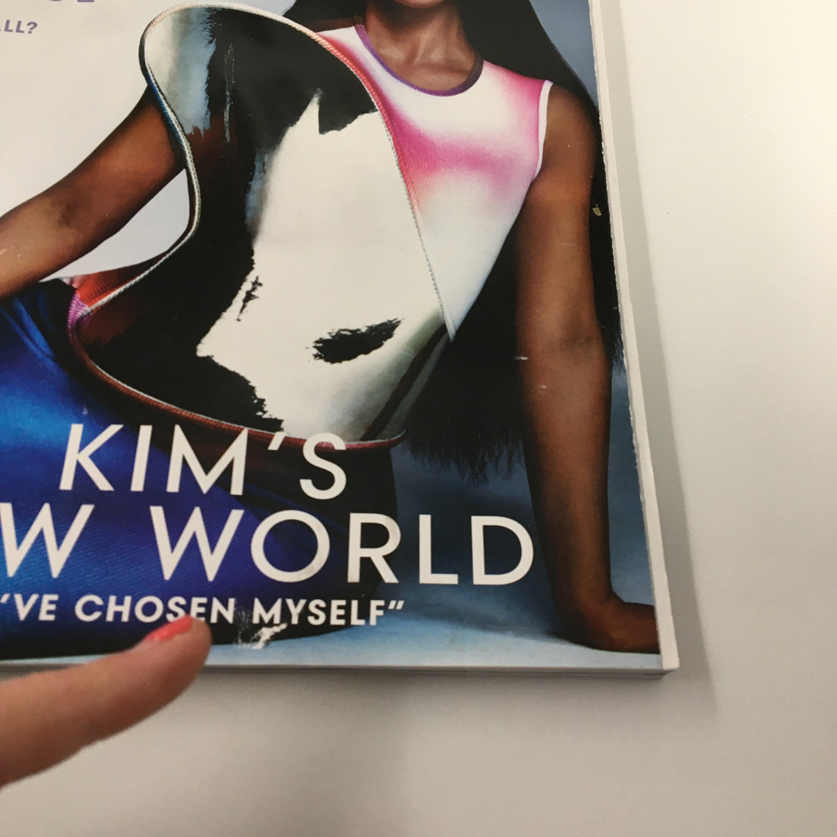 Close-up of Vogue Magazine March 2022 cover featuring Kim Kardashian with the title 'Kim's New World'. The image focuses on specific design elements and text, emphasizing Kardashian's influential presence in fashion.