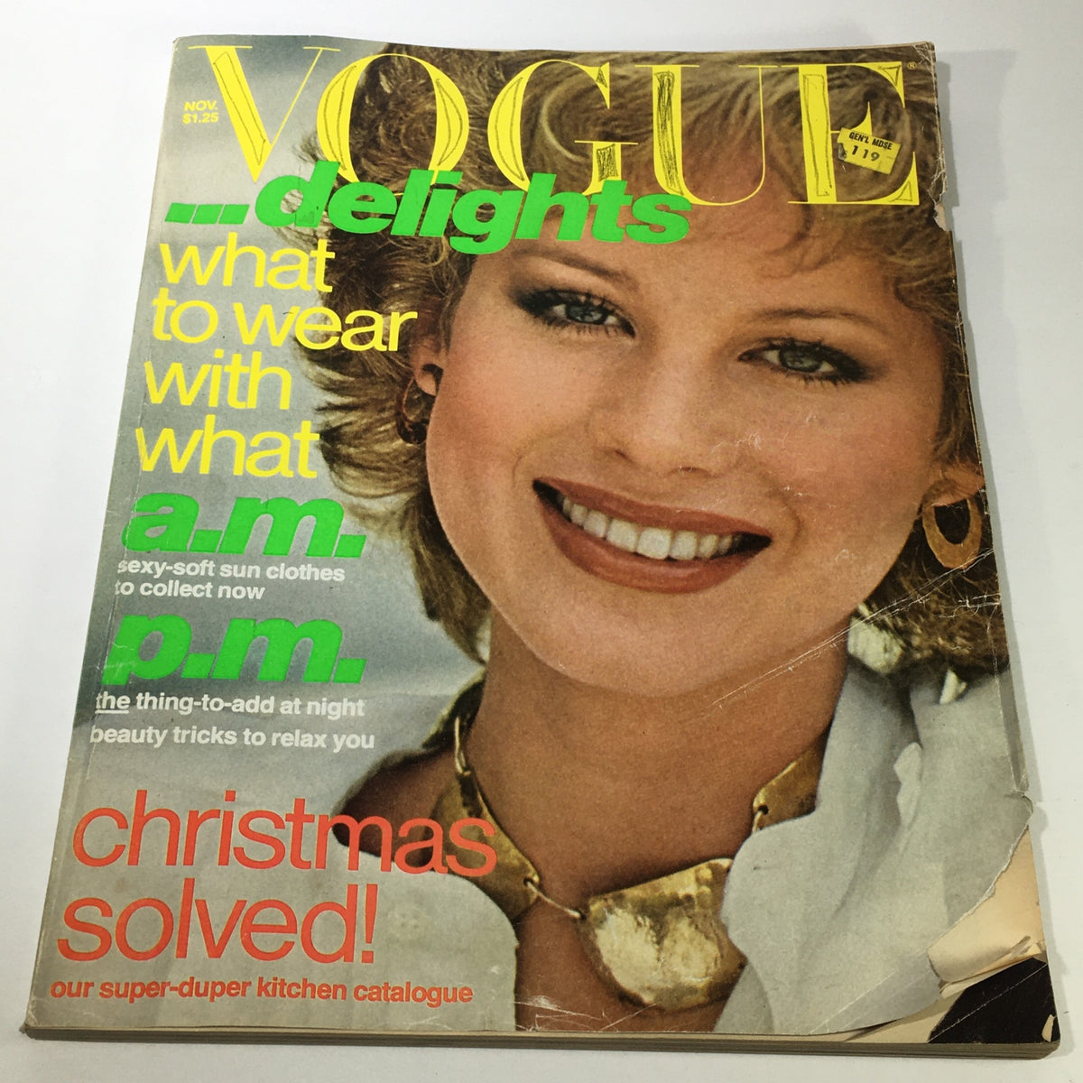 VTG Vogue Magazine November 1976 featuring a smiling model on the cover, highlighting fashion trends of the late 70s with bright colors and bold typography.