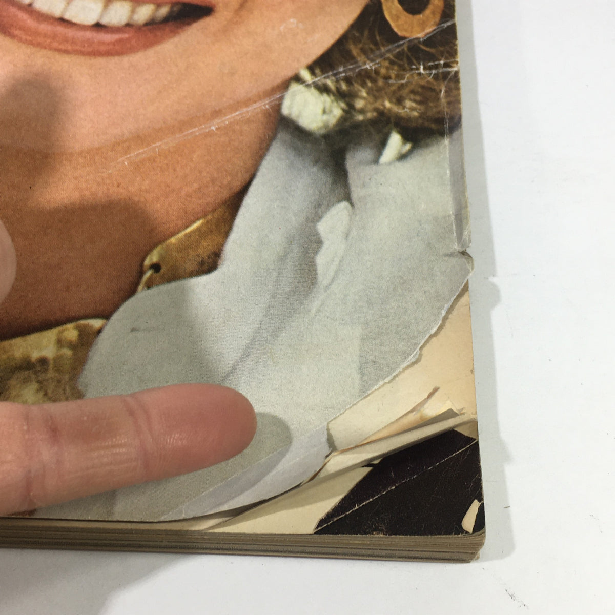 Close-up of VTG Vogue Magazine November 1976 cover showing a model with a fashionable outfit, capturing the magazine's vintage allure and condition details.