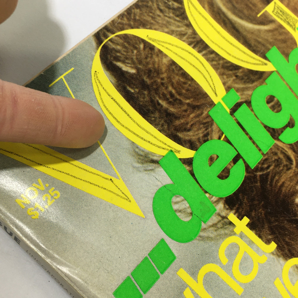 Detail of the price tag and month on the top corner of the November 1976 VTG Vogue Magazine, marked $1.25.