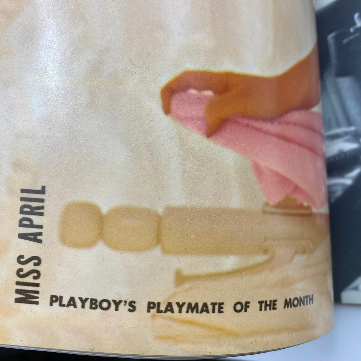 Close-up of the April 1974 Playboy Magazine page featuring Miss April, the Playmate of the Month, highlighting Marlene Morrow's iconic centerfold with lush imagery and vintage design.