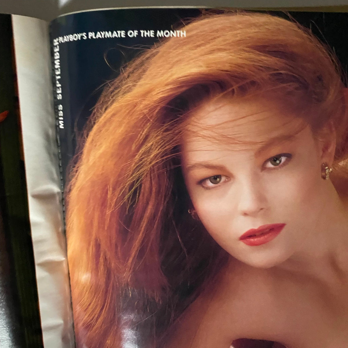 Interior page showcasing the Playmate of the Month in Playboy Magazine September 1988, featuring a beautiful model with striking red hair and captivating makeup.