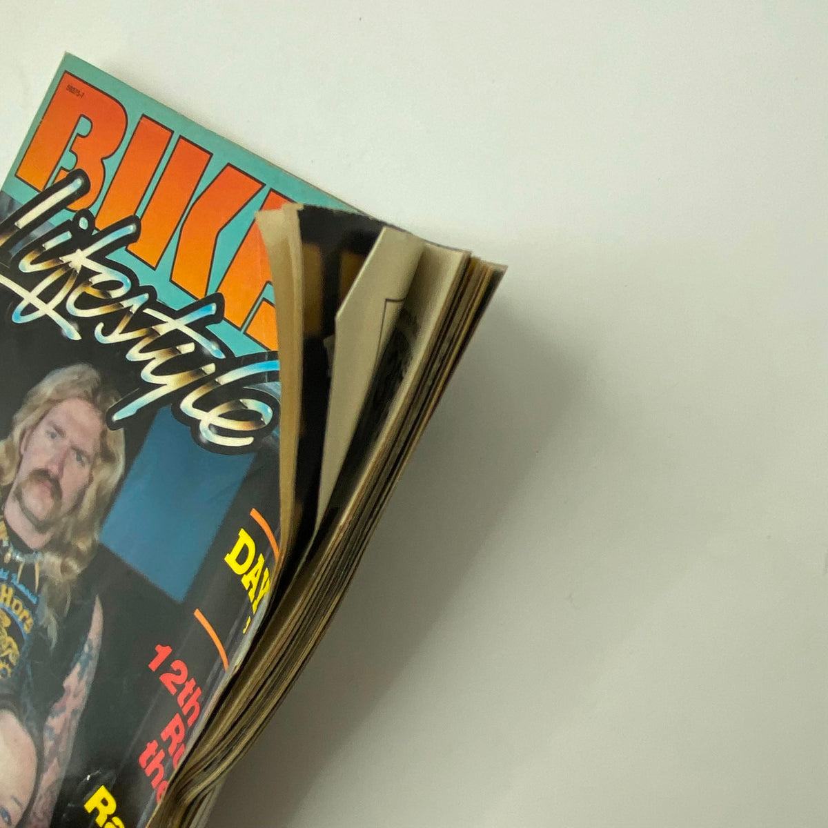 Side view of VTG Biker Lifestyle Magazine June 1984 showing slightly opened pages and the title, 'Ol' Ladies of Daytona', highlighting the magazine's vintage condition.