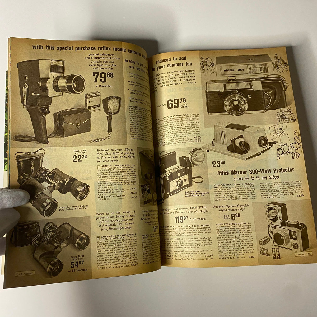 1965 JC Penneys Summer Store Catalog highlighting camera equipment and accessories for summer fun, including reflex movie cameras and projectors.