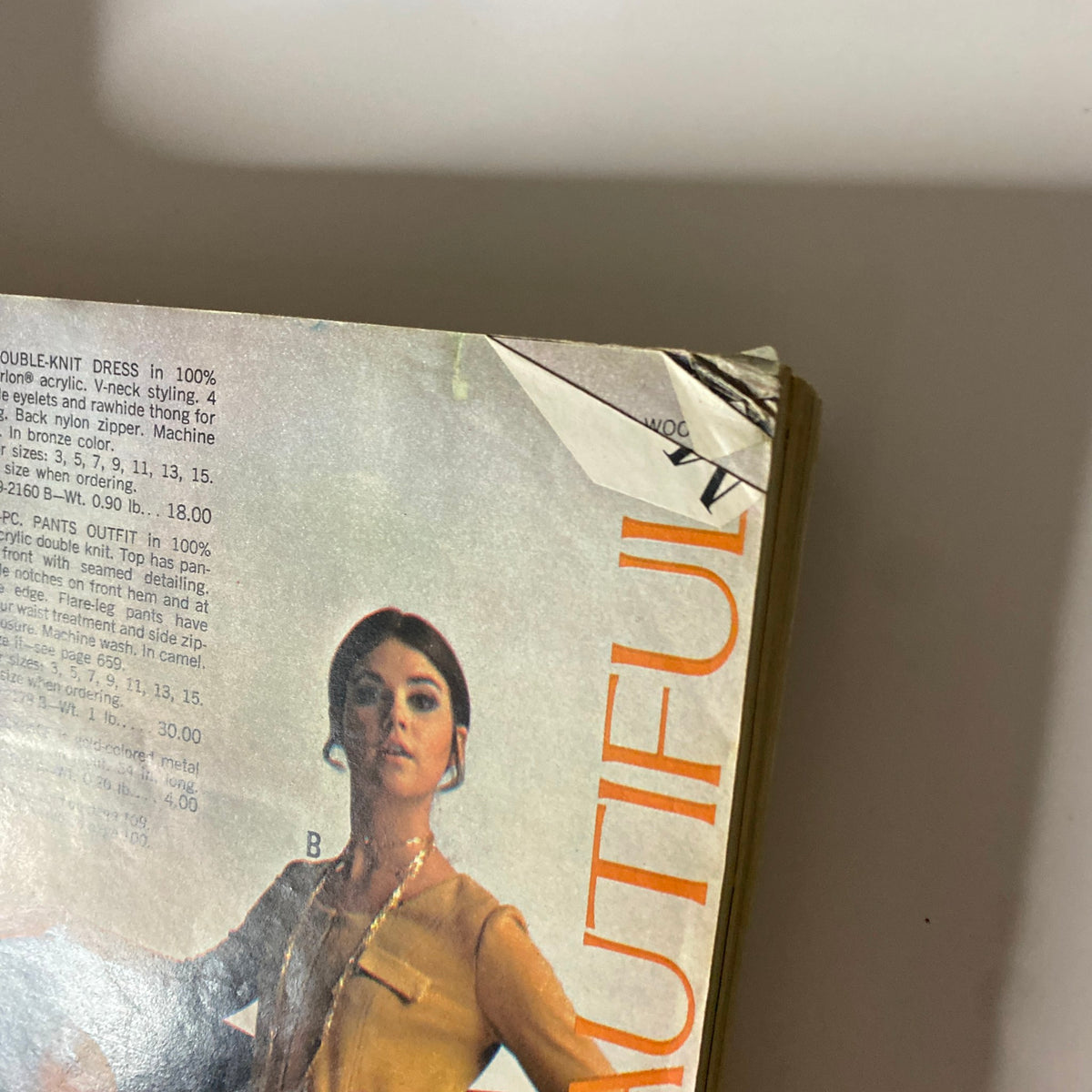 Close-up of a model in the 1969 JC Penneys Fall and Winter Store Catalog showcasing a double-knit dress with unique detailing, highlighting retro fashion trends.