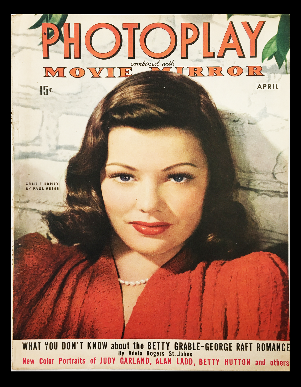 COVER ONLY of Photoplay Movie Mirror Magazine from April 1943 featuring Gene Tierney. The cover showcases Gene Tierney with a glamorous hairstyle, wearing a red dress, along with the magazine's title and headlines highlighting movie stars.