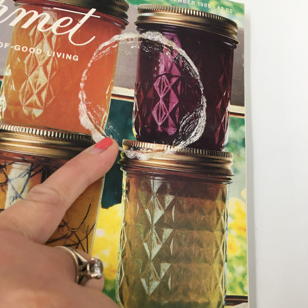 Close-up of VTG Gourmet Magazine September 1985 cover, highlighting colorful jellies with a fingerprint smudge, showcasing a vintage magazine dedicated to fruit and vegetable preserves.
