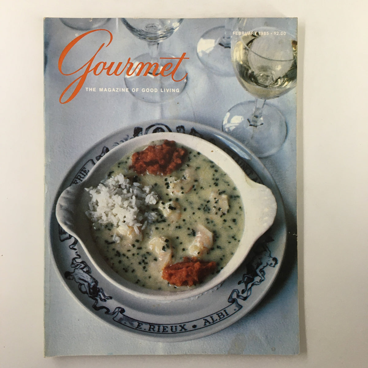 Cover of the February 1985 issue of Gourmet magazine featuring a dish with rice, sauce, and garnishes, symbolizing culinary excellence at the Hostellerie Saint-Antoine.