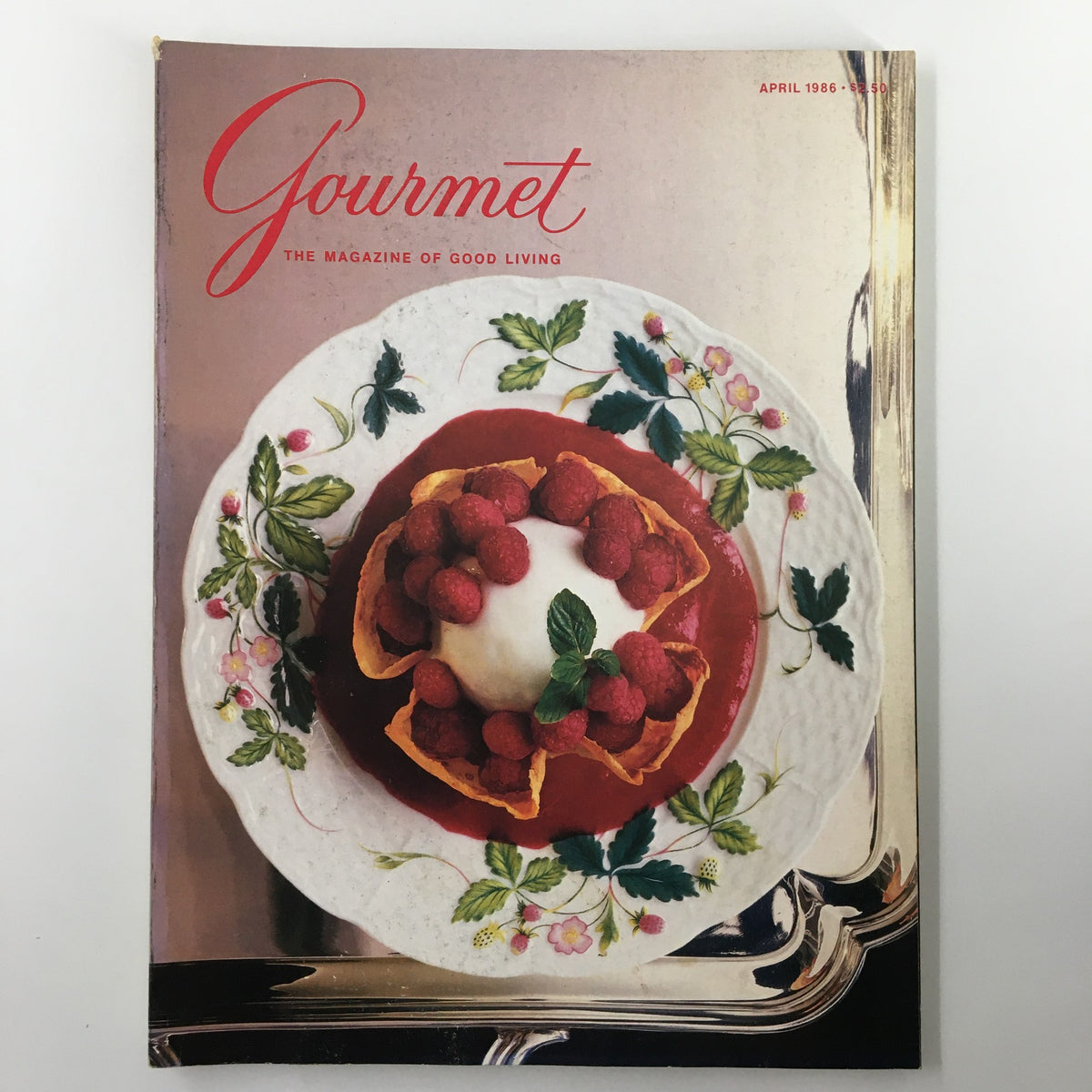 Cover page of VTG Gourmet Magazine April 1986 featuring a beautiful dessert of lemon sherbet served in a crepe tulipe, adorned with fresh raspberries and mint on a decorative plate.