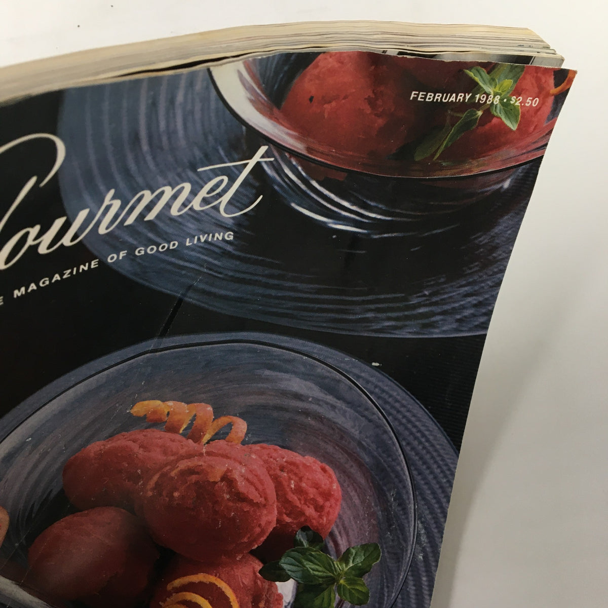 Close-up view of the cover of VTG Gourmet Magazine February 1988, highlighting the month and price alongside a red sorbet dessert.