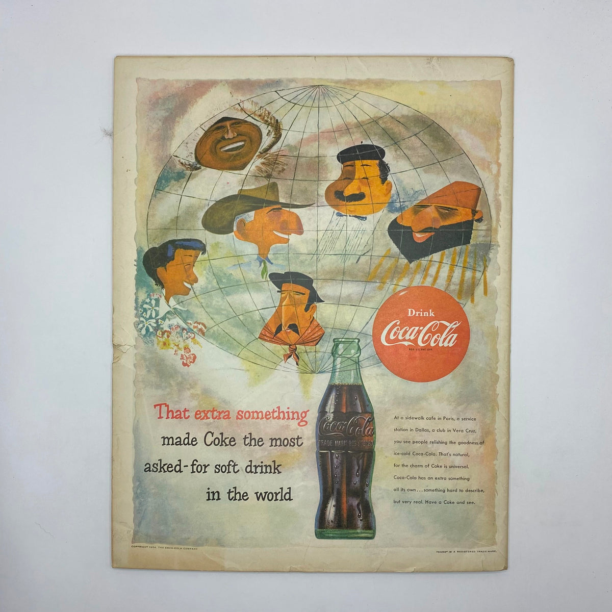 Vintage Coca-Cola advertisement featuring a globe and cartoon characters, accompanied by the text about Coke's popularity, from Boys' Life for All Boys Magazine May 1954 Pedro The Shod Mail Carrier.
