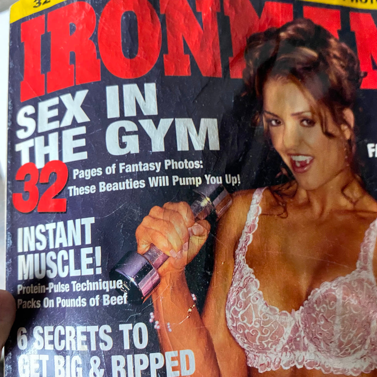Close-up of Iron Man Magazine December 2001 cover highlighting the text 'Sex in the Gym' and a model promoting muscle-building techniques.