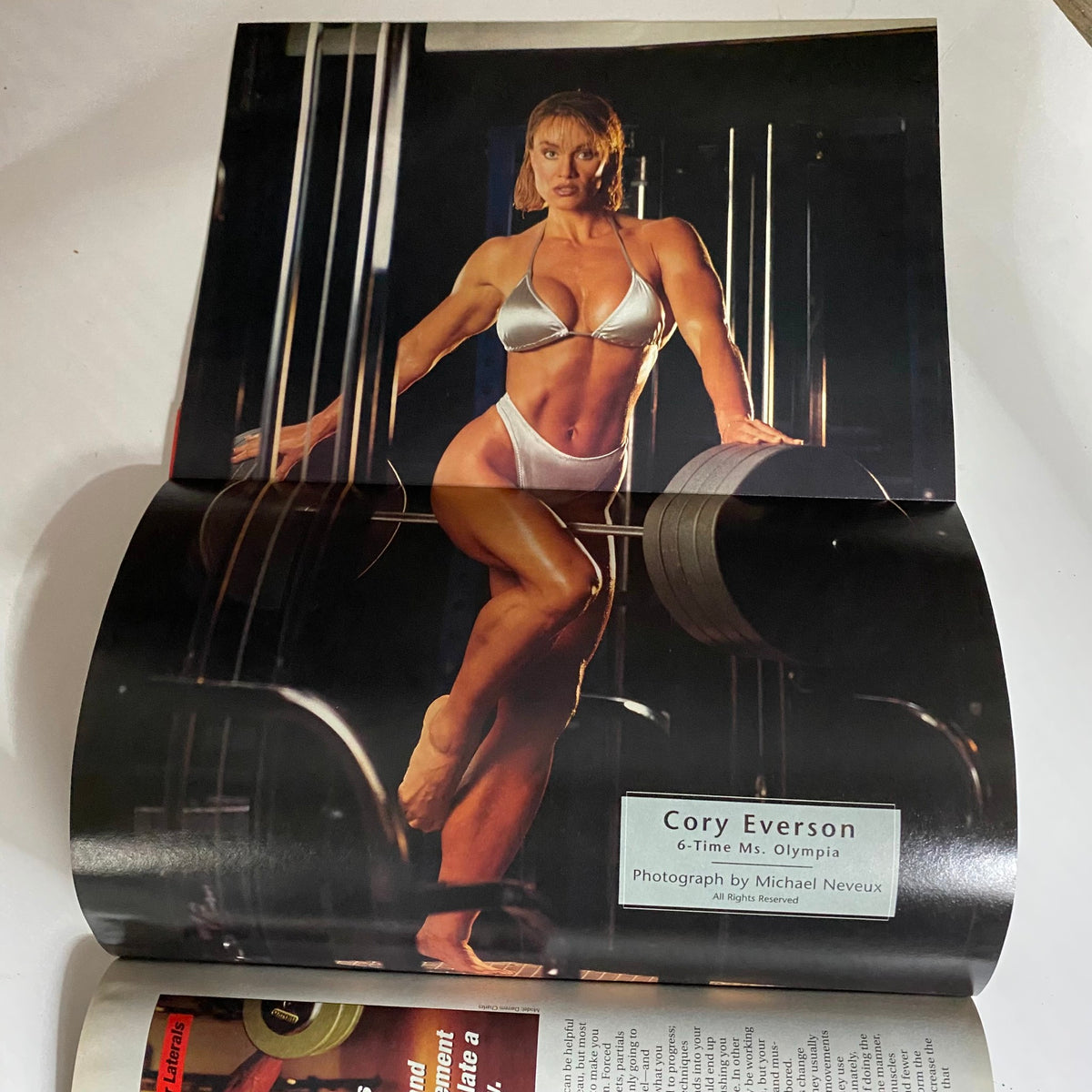 Inside page of Iron Man Magazine October 2005 showcasing Cory Everson, 6-time Ms. Olympia, in a posed photo highlighting her athletic physique.