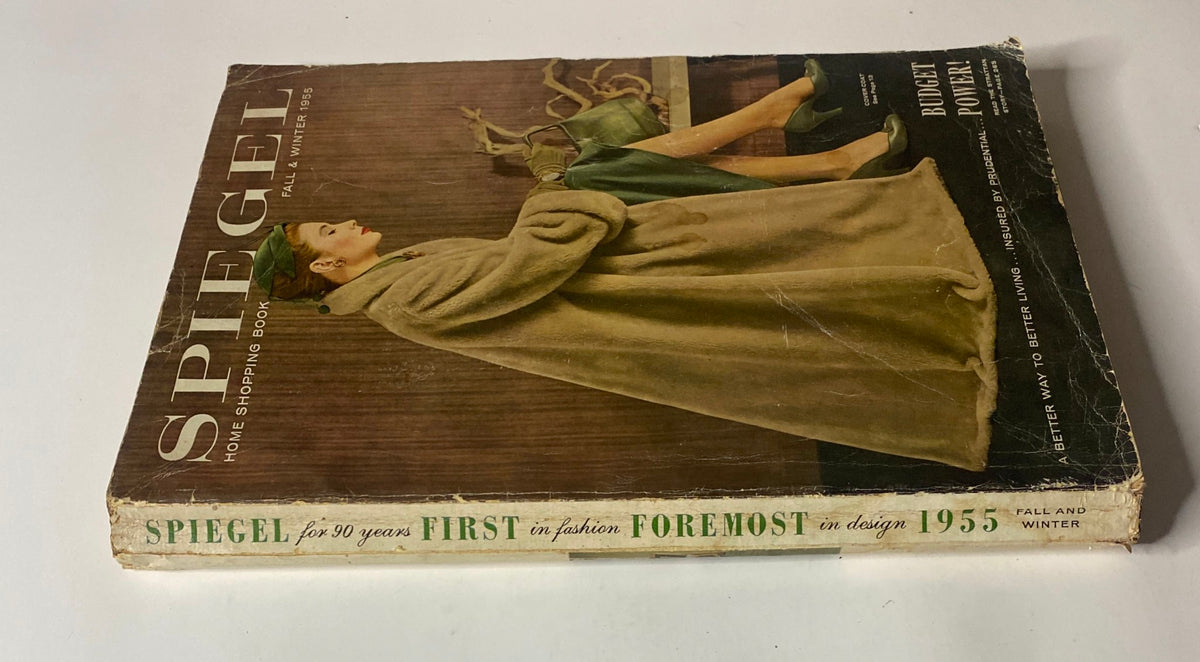 Side view of the 1955 Spiegel Fall and Winter Catalog showcasing the elegant design of the cover with the woman in a cozy coat.