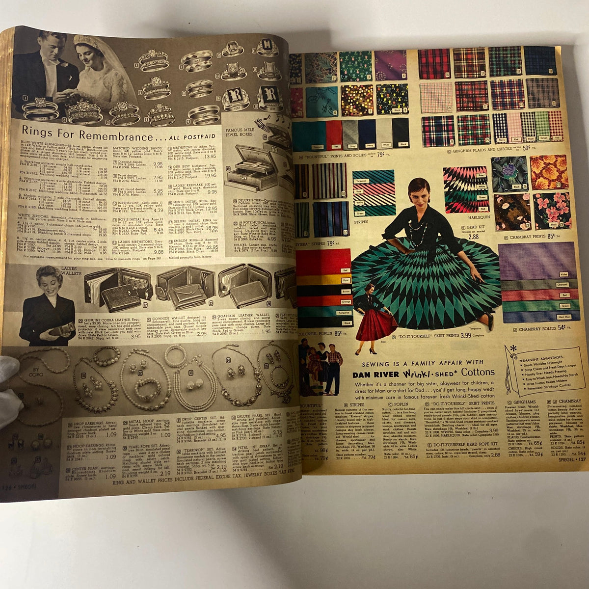 1955 Spiegel Fall and Winter Catalog featuring a colorful display of jewelry and fabrics, emphasizing fashion accessories and sewing materials.