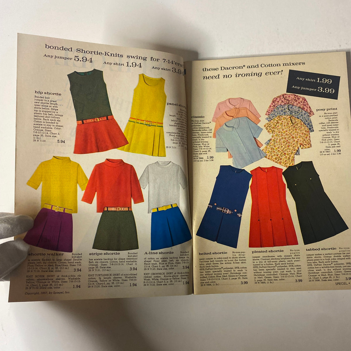 Interior pages of the 1967 Spiegel Fall Catalog displaying an assortment of fashionable clothing, including bonded Shortie-Knits dresses and colorful garments with prices listed.