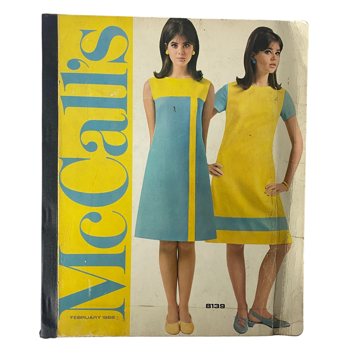 Cover of the 1966 February McCall's Designers' Collection catalog featuring two women modeling colorful mid-1960s dresses in blue and yellow.