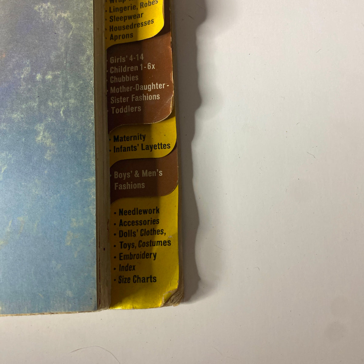 Side view of the 1968 November McCall's Holiday Wear Catalog showing sections for various clothing categories including maternity, boys' and men's fashions, and children's sizes.