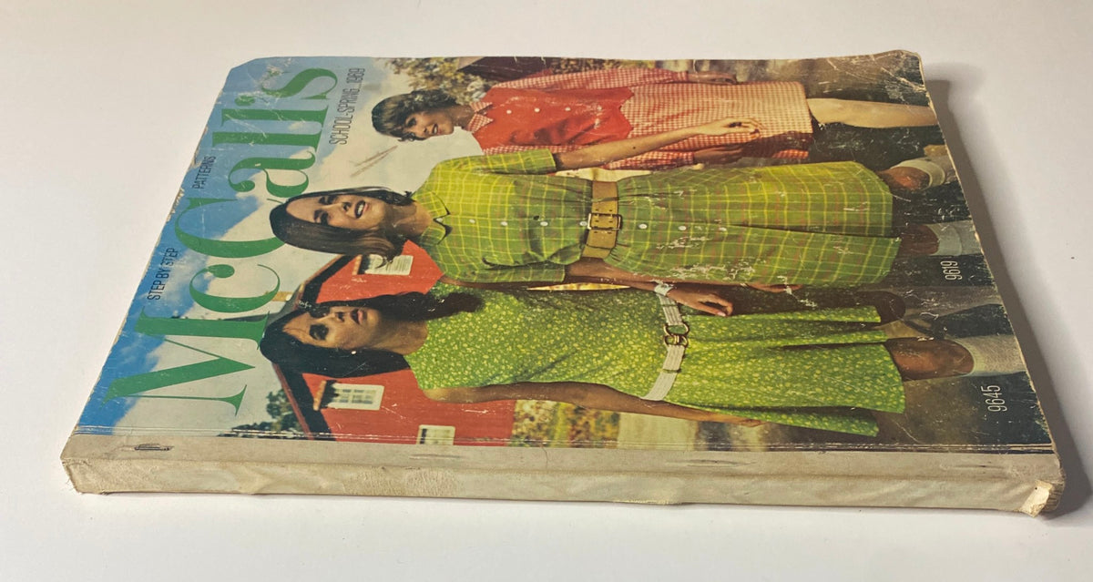 1969 McCall's School Spring Catalog displayed at an angle, highlighting its vintage cover design with models wearing trendy outfits from the 1960s.