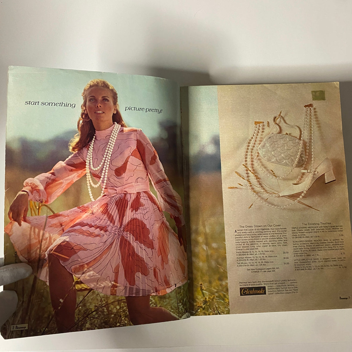 Inside spread of the 1970 JC Penneys Spring and Summer Store Catalog featuring a model in a pink dress surrounded by a field, showcasing a fashion advertisement.