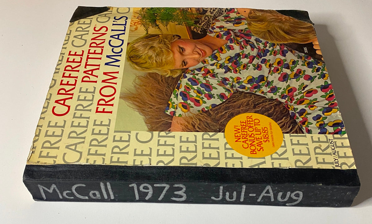 Another angle of the 1973 July - August McCall's Carefree Patterns Catalog, highlighting the same cheerful cover design and featuring a bonus offer message.