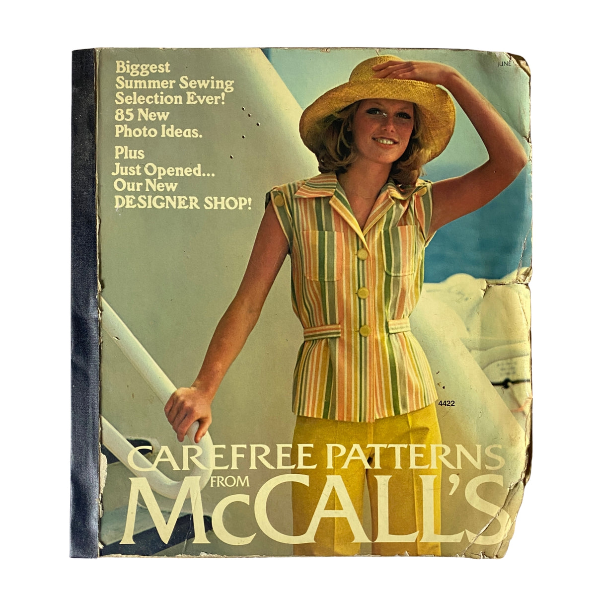 Front cover of the 1975 Carefree Patterns McCall's Summer Catalog featuring a model in a striped outfit and a straw hat, promoting summer sewing ideas.