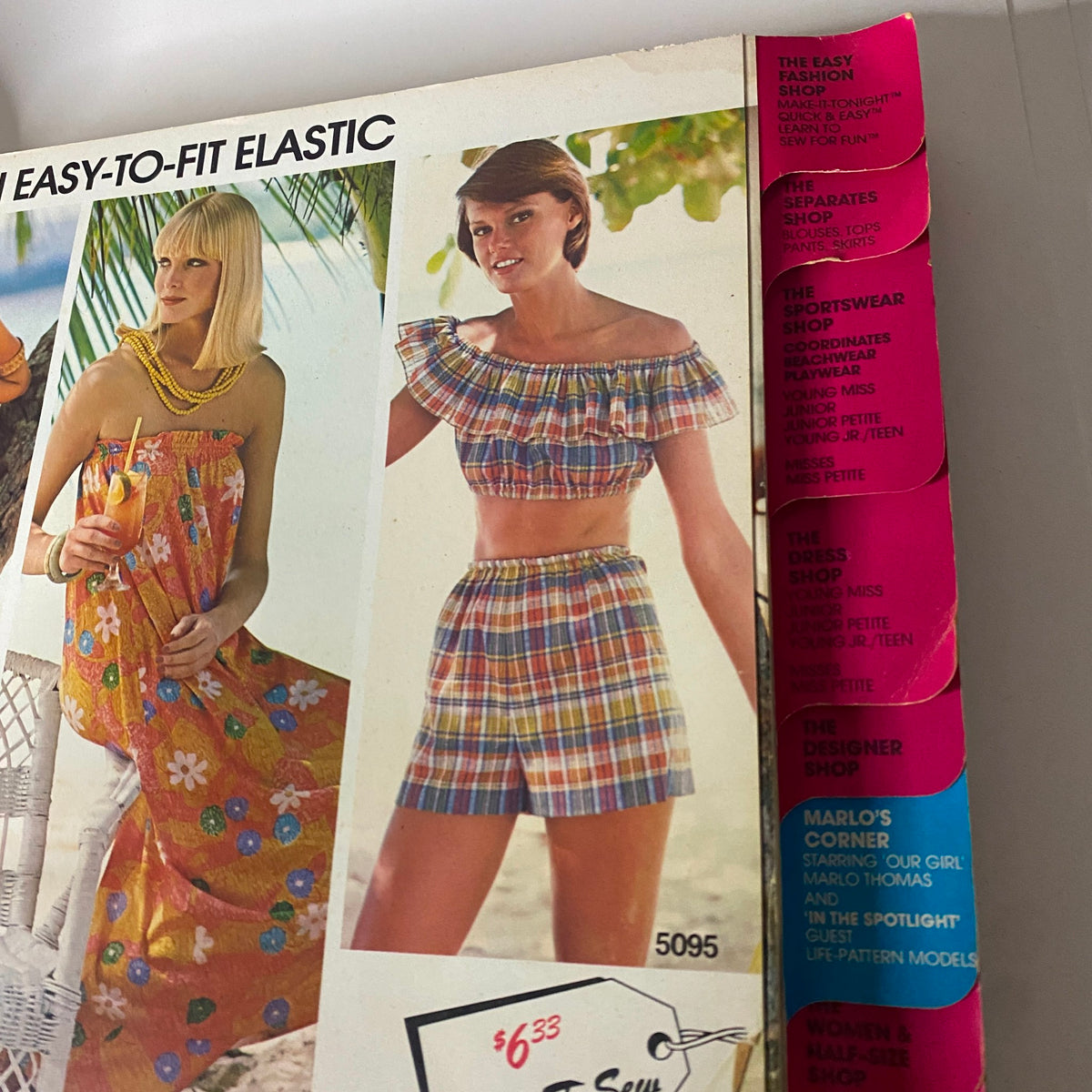 Inside of the 1975 July-August Carefree Patterns McCall's Catalog showcasing two models in vibrant summer outfits, promoting easy sewing patterns and fashion options for the season.