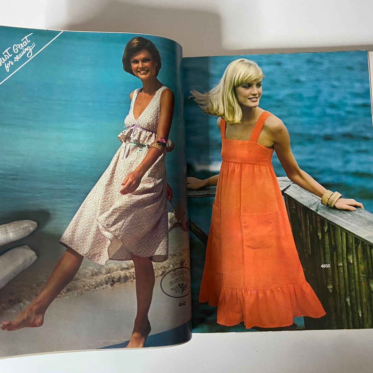 1975 July-August Carefree Patterns McCall's Catalog showing fashionable summer dresses and ensembles. The image features models dressed in various chic styles perfect for warm weather.