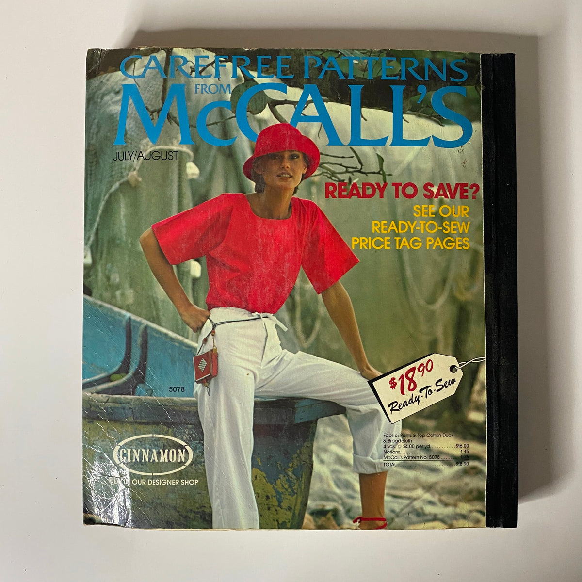 1975 July-August Carefree Patterns McCall's Catalog cover featuring a model in a red top and hat, promoting summer sewing patterns with a price tag of $18.90. The vintage catalog reflects the laid-back style of the 1970s fashion era.