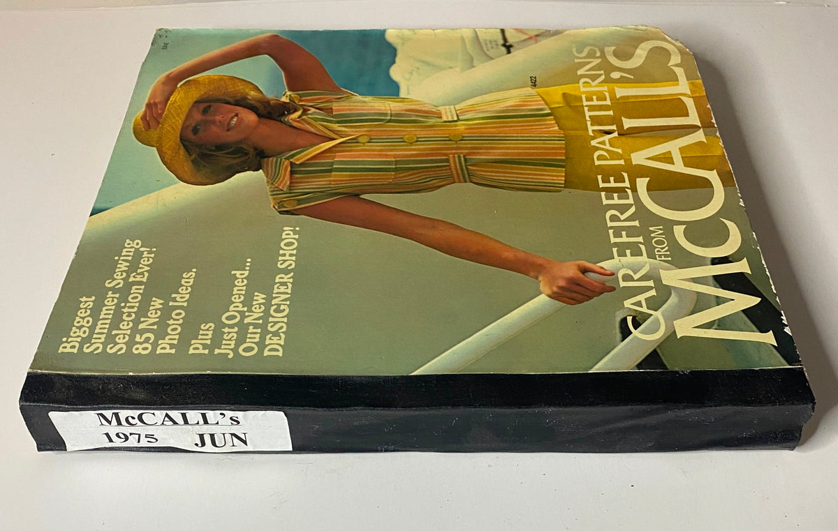 1975 June Carefree Patterns McCall's Catalog side view showing the vibrant cover design with a woman in a summer outfit, indicating multiple photo ideas for sewing.
