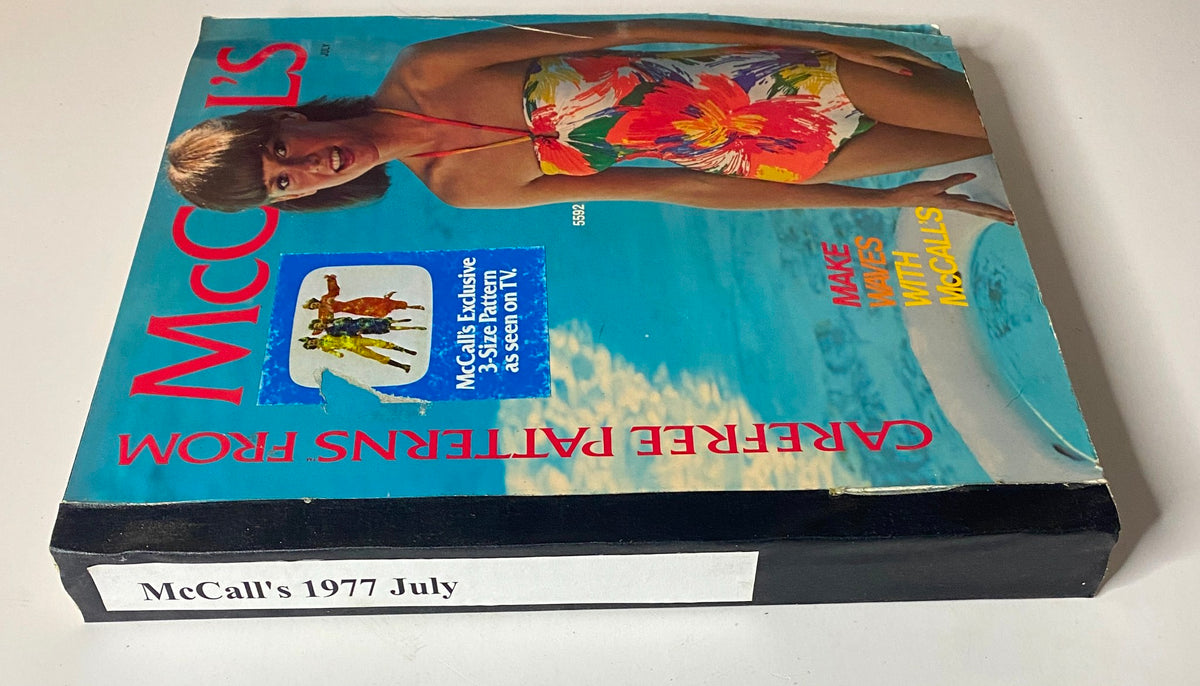 Spine view of the 1977 July Carefree Patterns McCall's Catalog, showcasing the brand's logo and a model in swimwear with a bold floral pattern.