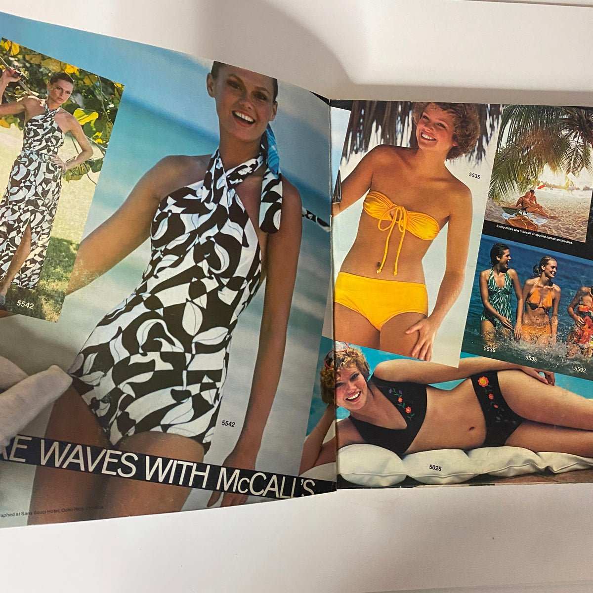 Inside spread of the 1977 July Carefree Patterns McCall's Catalog displaying various summer swimwear styles, including halter swim dresses and bikini sets.