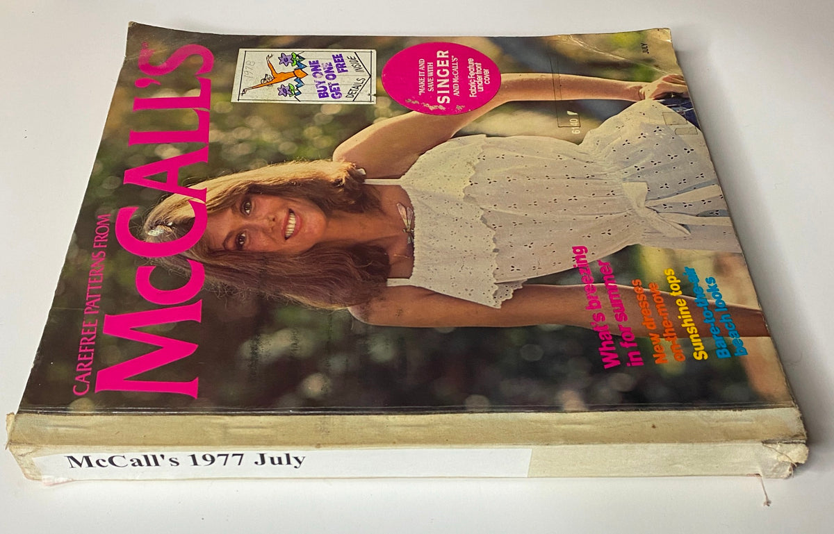 Side view of the 1977 July Carefree Patterns from McCall's Summer Catalog with a woman in a white sundress.
