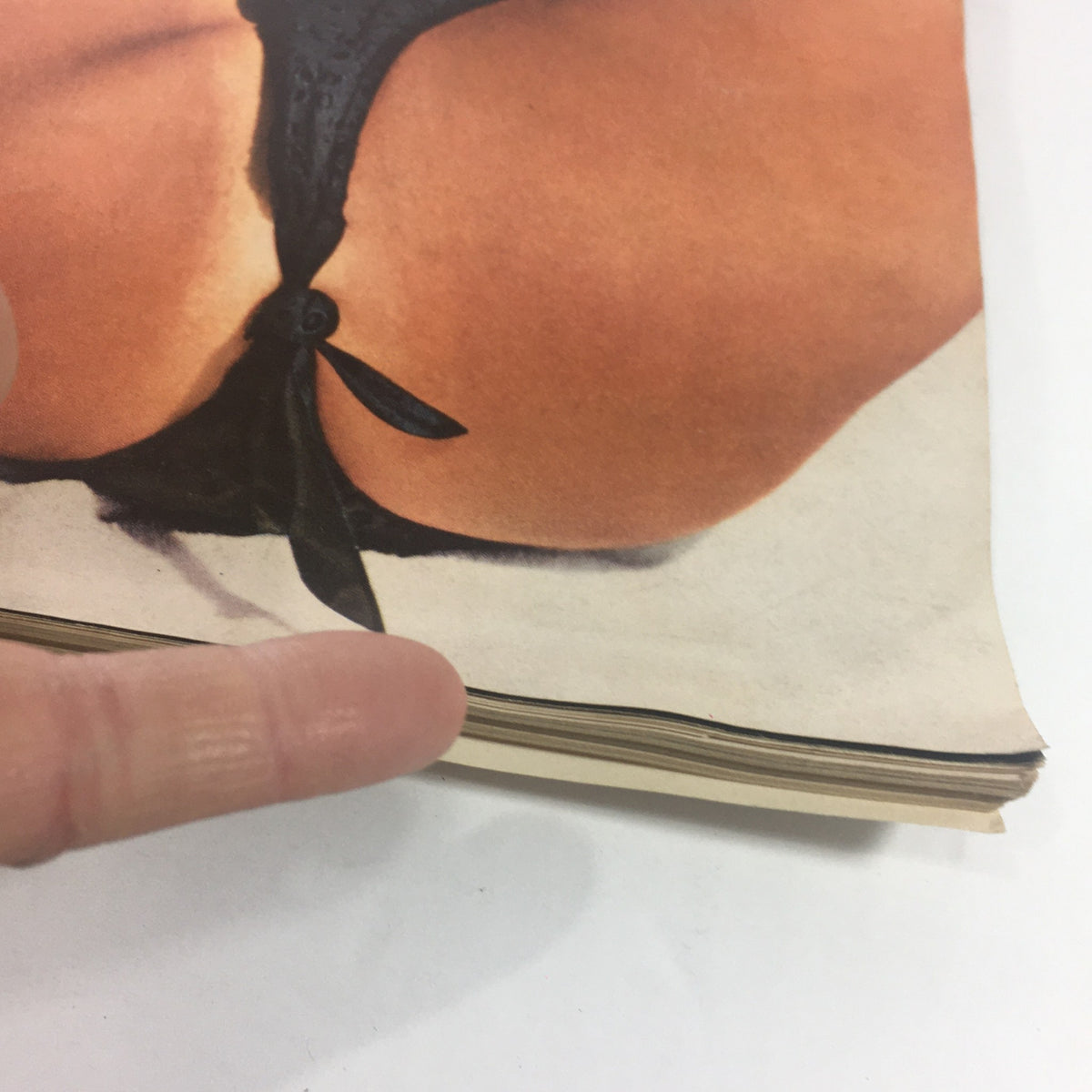 VTG Playboy Magazine: June 1962 showcasing a detailed view of the bikini knot and edges of the magazine, emphasizing its condition and historical value for collectors.