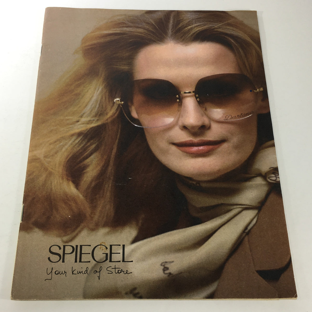 VTG Spiegel Store Catalog 1978 featuring a model wearing stylish oversized sunglasses and a printed scarf, showcasing fashion trends from the era.