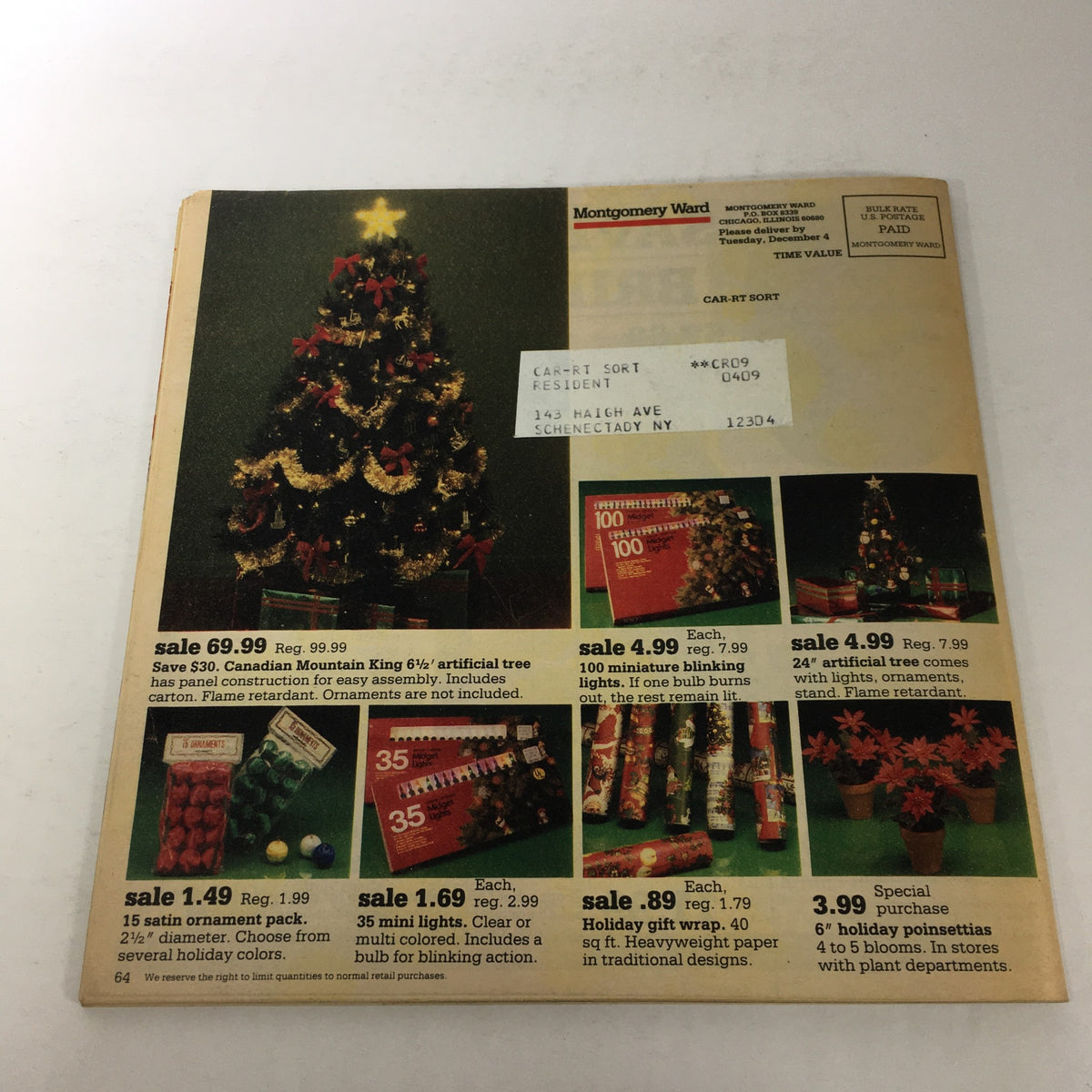 Image from VTG Montgomery Ward Store Catalog: December 1984 - A Gift Of Joy This Holiday showcasing a Christmas tree and holiday decorations for sale including an artificial tree, lights, ornaments, and gift wrap options.