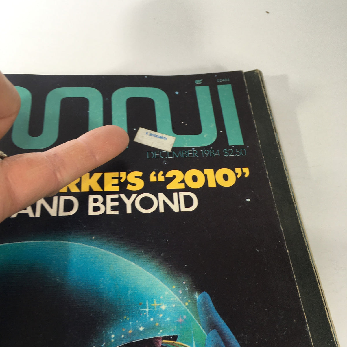 Close-up of the cover of Omni Magazine December 1984 showcasing Arthur C. Clarke's '2010' with a visible price sticker.