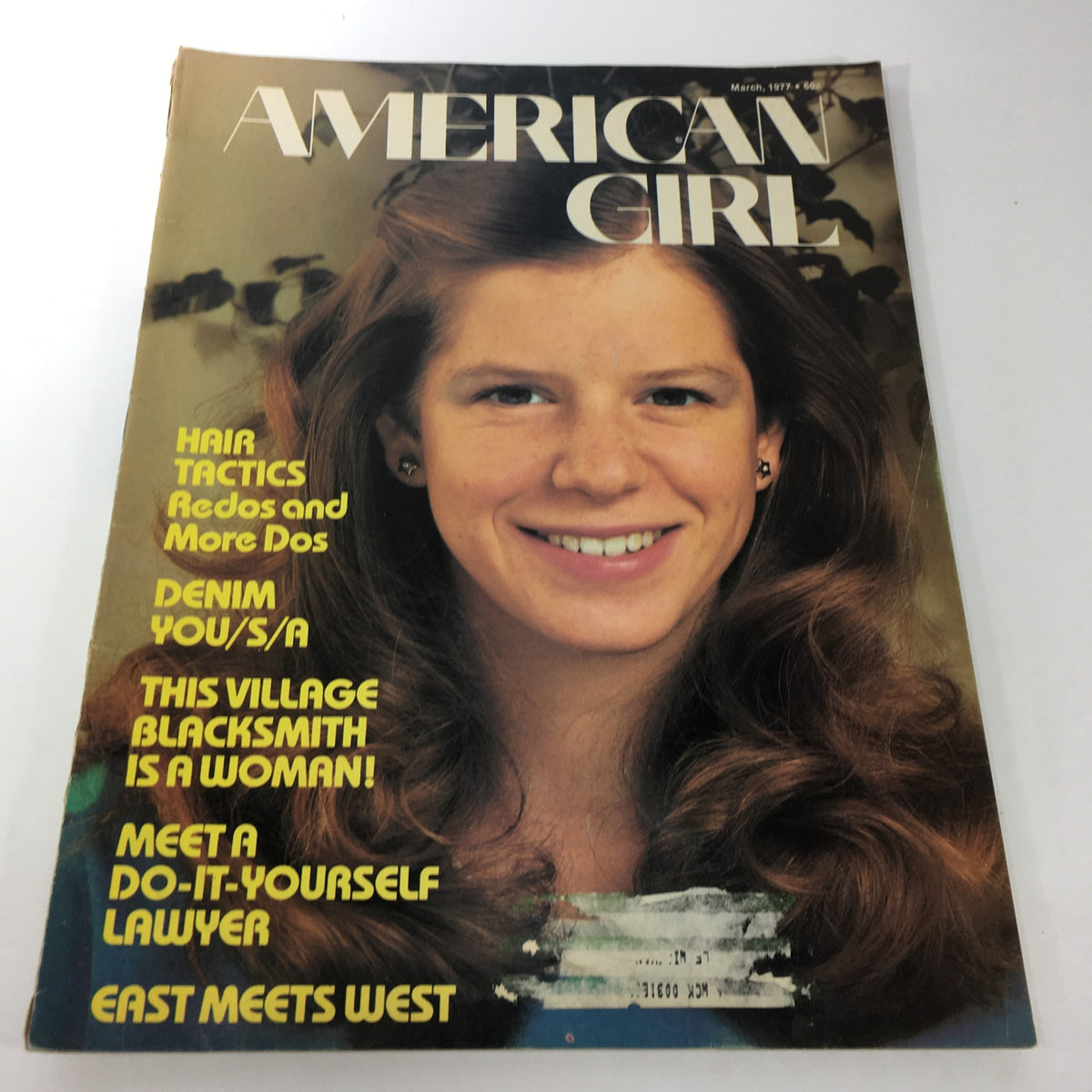 Cover of VTG American Girl Magazine from March 1977 featuring the title 'This Village Blacksmith Is A Woman', showcasing a smiling girl with styled hair.