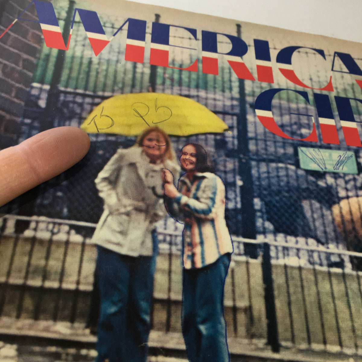 Close-up of the Vintage American Girl Magazine July 1973 cover highlighting two girls smiling under an umbrella and details of the magazine's title.