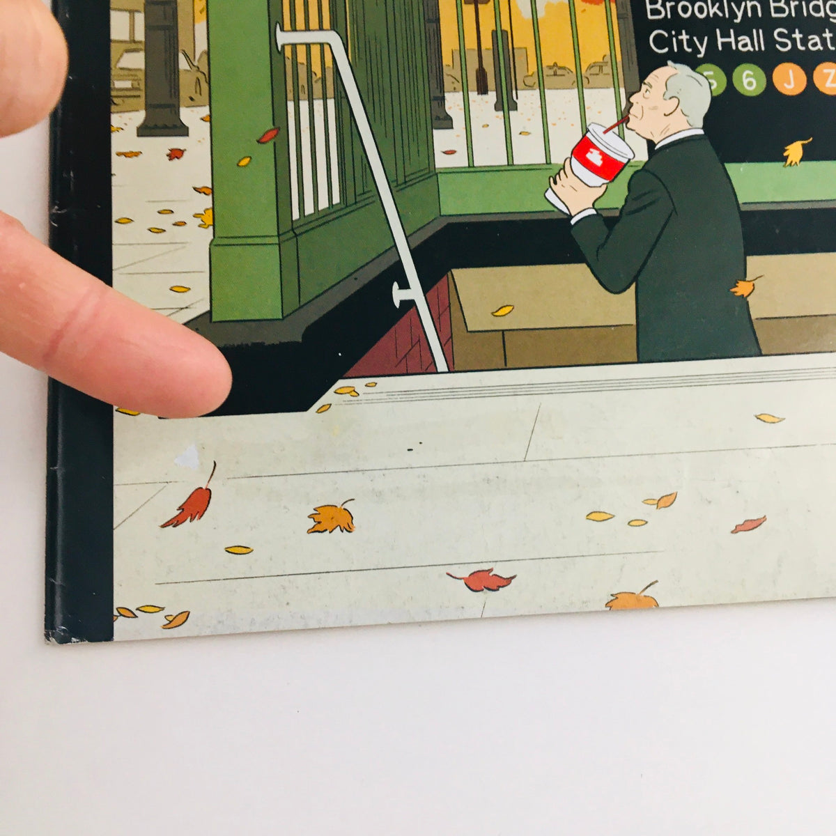 The New Yorker November 18 2013 Full Magazine, featuring a hand pointing to an illustration depicting a man near a subway entrance, designed by Adrian Tomine. This vintage magazine showcases urban life and artistic details.