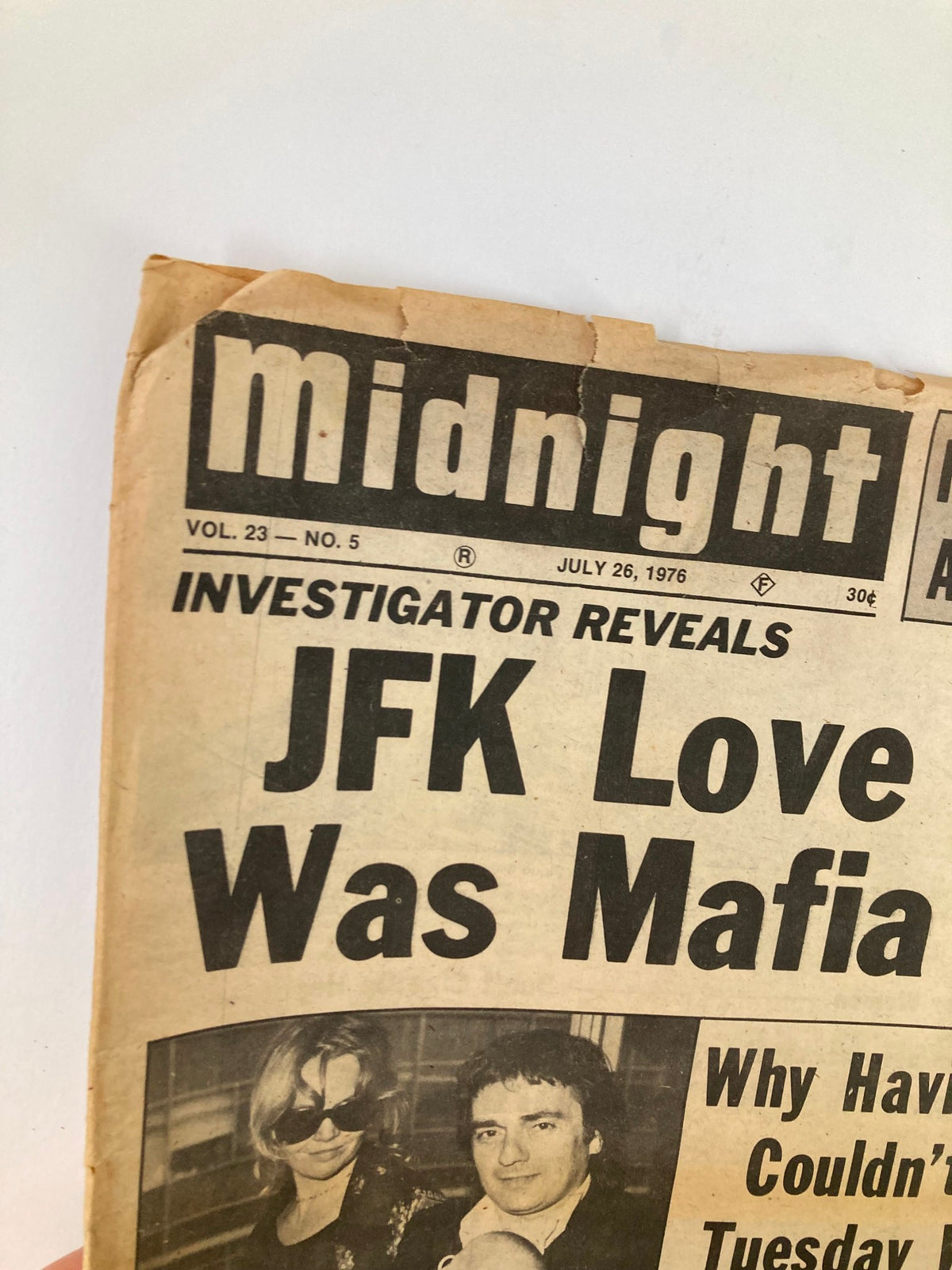 Close-up of Midnight Tabloid July 26 1976 Vol 23 #5 highlighting the JFK love girl and mafia spy story, with visible wear and aging on the newspaper.