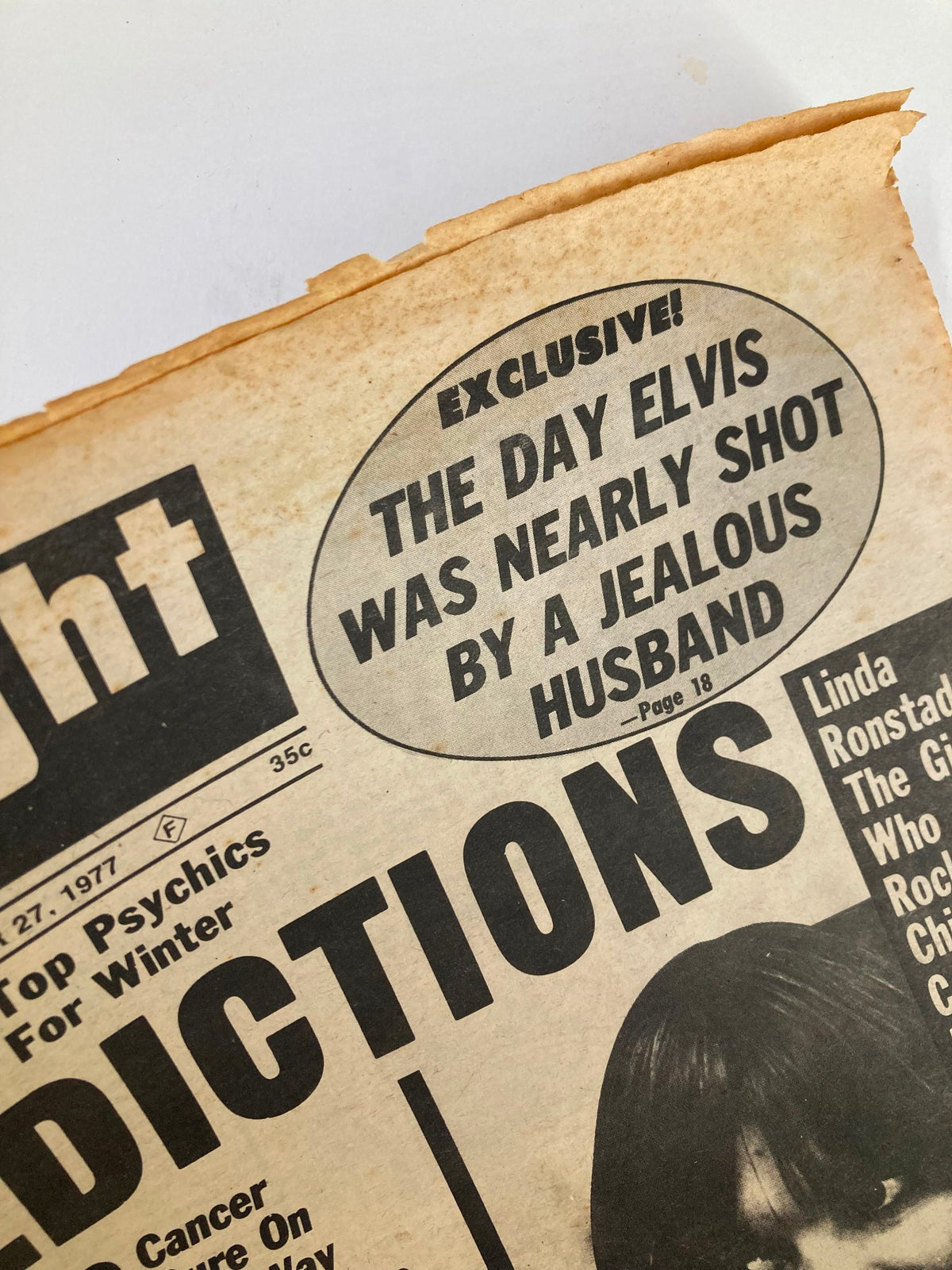Close-up of the Midnight Globe Tabloid headline stating 'Exclusive: The Day Elvis Was Nearly Shot by a Jealous Husband,' from September 27, 1977, Vol 24 #15.